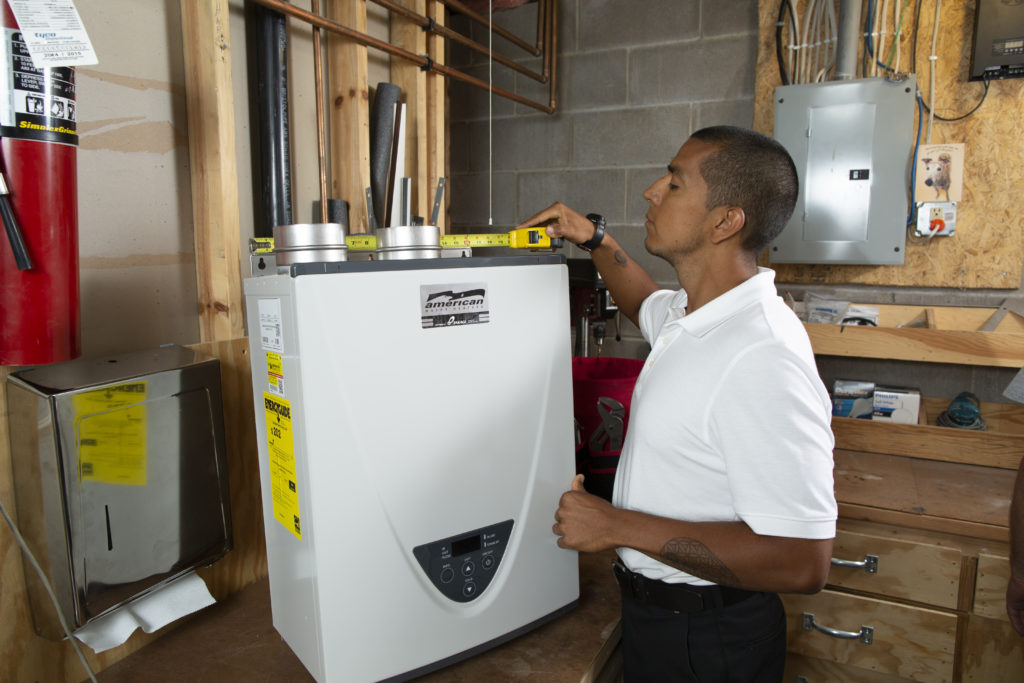 Plumber preparing to install a new tankless water heater unit