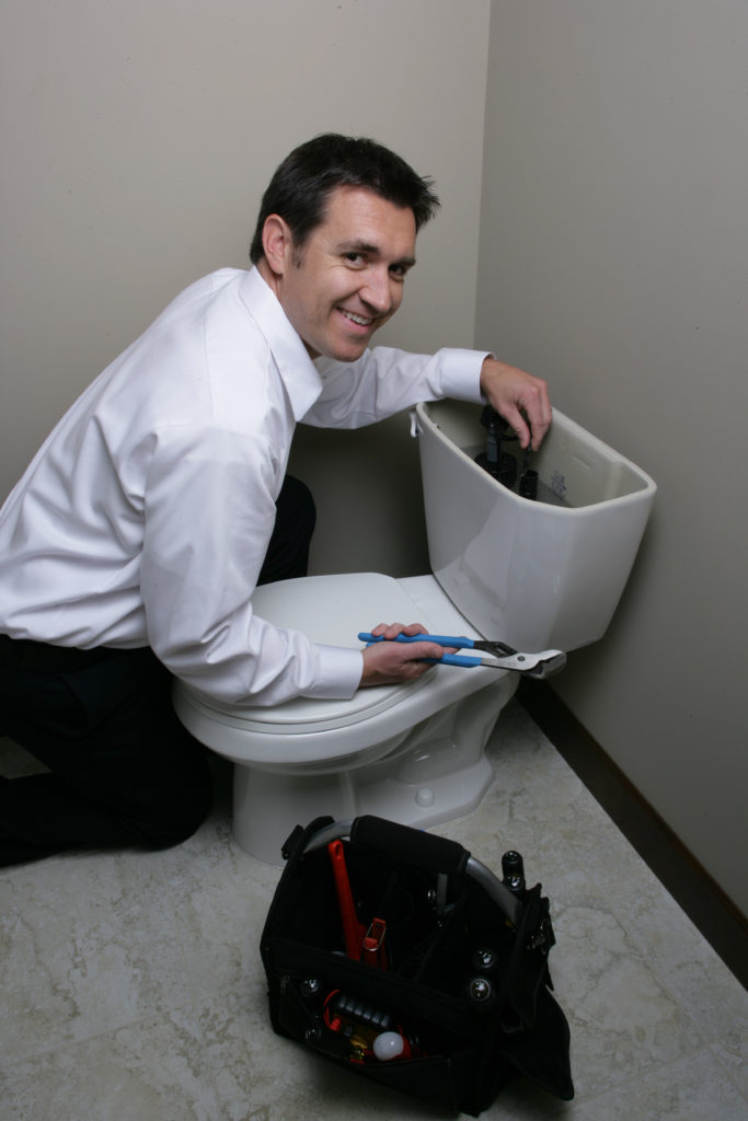 One of our plumbers finishing up a routine toilet installation in Spring, Texas