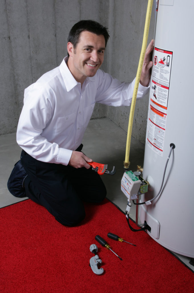 Plumber repairing a residential hot water heater